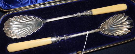 A cased pair of late Victorian ivory handled silver salad servers by William Hutton & Sons.